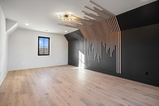 bonus room featuring vaulted ceiling and light hardwood / wood-style flooring