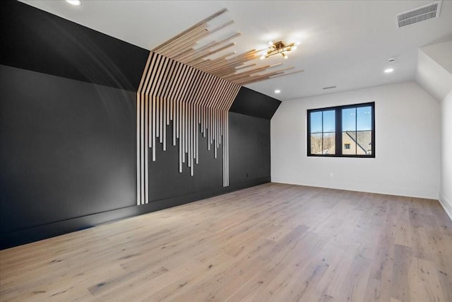 bonus room featuring vaulted ceiling and light hardwood / wood-style flooring