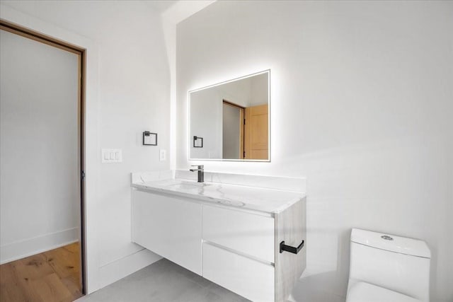 bathroom featuring vanity and toilet