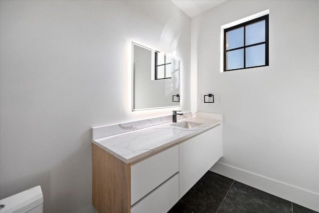 bathroom featuring vanity, toilet, and tile patterned flooring