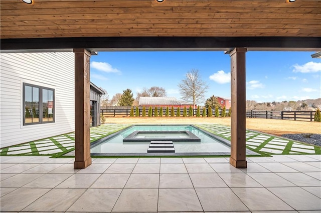 view of patio / terrace featuring a swimming pool with hot tub