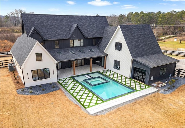 exterior space with a patio area, central AC, and an in ground hot tub