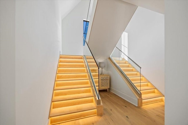 stairway with hardwood / wood-style flooring