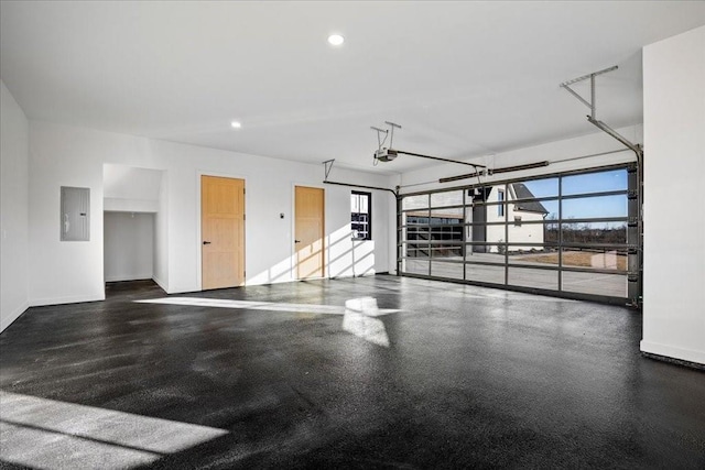 garage with a garage door opener and electric panel