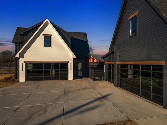 property exterior at dusk featuring a garage