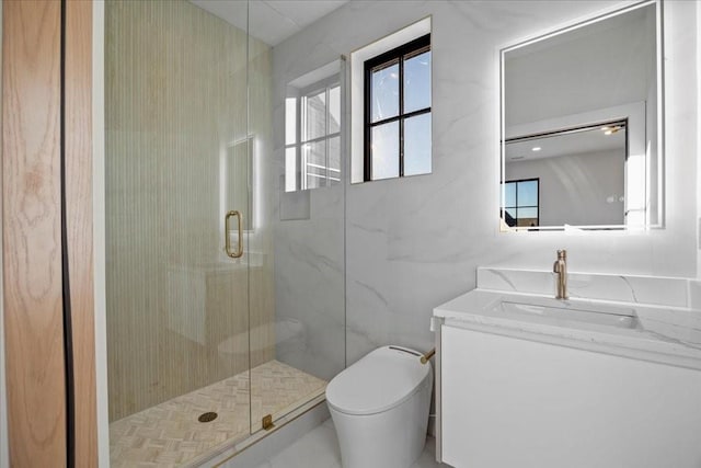 bathroom featuring toilet, vanity, and walk in shower