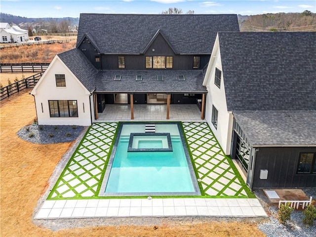 back of house with a pool with hot tub and a patio