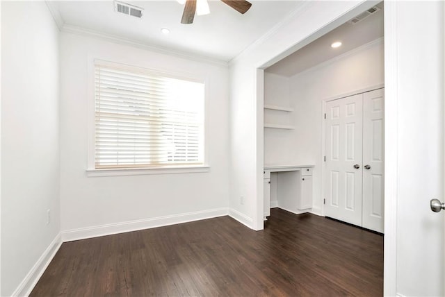 unfurnished bedroom with visible vents, baseboards, dark wood finished floors, and ornamental molding