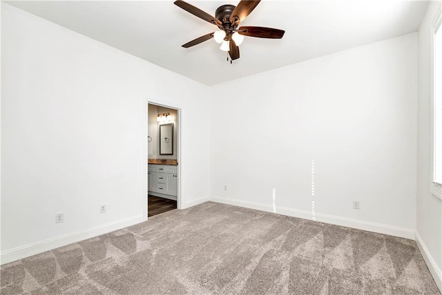 carpeted empty room featuring ceiling fan