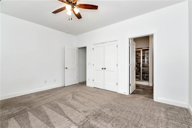 unfurnished bedroom featuring carpet floors, a ceiling fan, baseboards, a closet, and ensuite bath