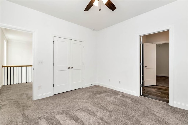 unfurnished bedroom with carpet flooring, a closet, and ceiling fan