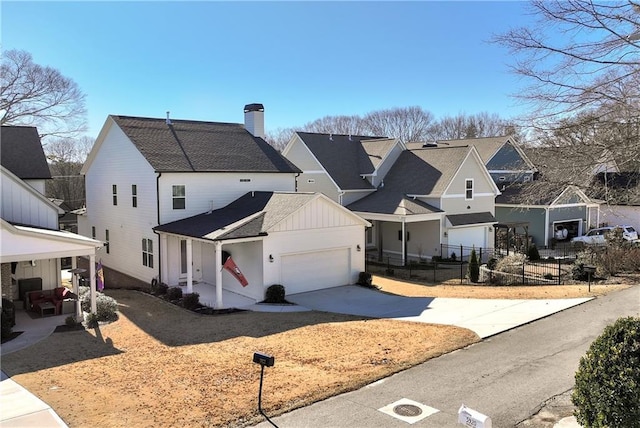 modern inspired farmhouse with a garage, a residential view, concrete driveway, and a chimney