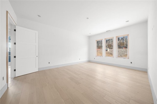 spare room with light hardwood / wood-style floors