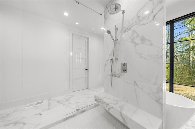 bathroom featuring a healthy amount of sunlight and separate shower and tub