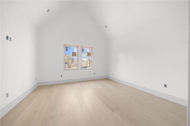 interior space with light hardwood / wood-style floors and high vaulted ceiling