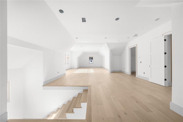 bonus room featuring lofted ceiling and light hardwood / wood-style flooring