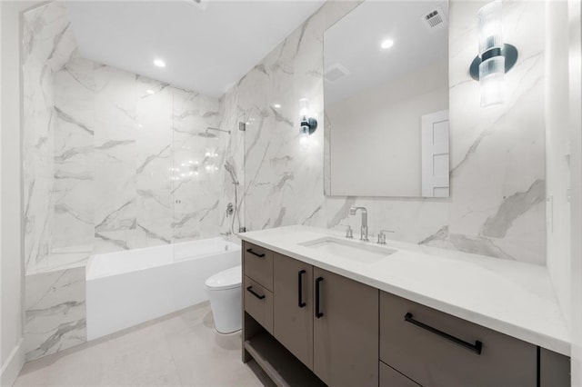 full bathroom with toilet, tile walls, vanity, and bathtub / shower combination