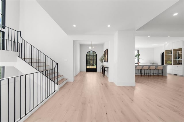 foyer with an inviting chandelier and light hardwood / wood-style floors