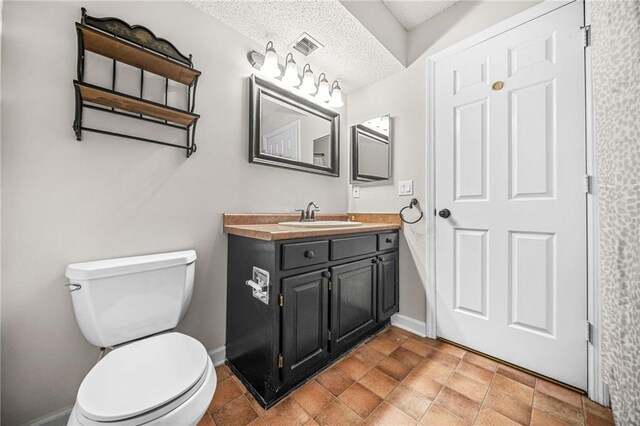 23 Chelsea Ct, Avondale Estates, GA 30002 - bathroom with toilet, a textured ceiling, vanity, baseboards, and visible vents
