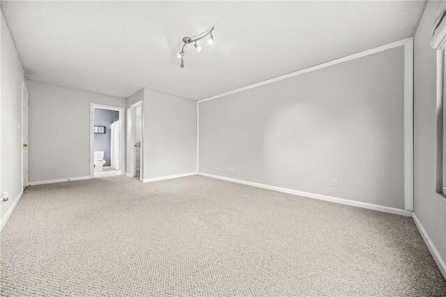 23 Chelsea Ct, Avondale Estates, GA 30002 - unfurnished bedroom featuring a textured ceiling, carpet flooring, baseboards, and ensuite bathroom