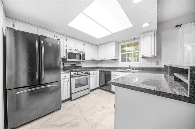 23 Chelsea Ct, Avondale Estates, GA 30002 - kitchen with marble finish floor, stainless steel appliances, a textured ceiling, and recessed lighting