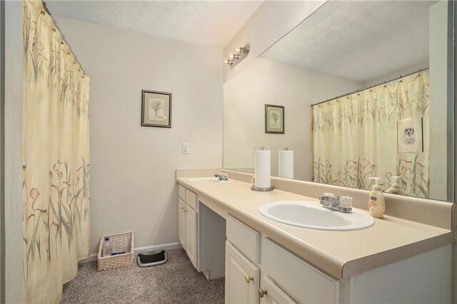 bathroom featuring vanity and a textured ceiling