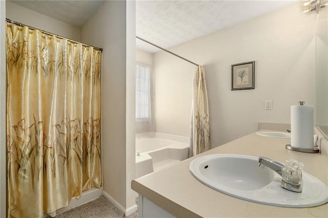 bathroom featuring separate shower and tub, vanity, and a textured ceiling