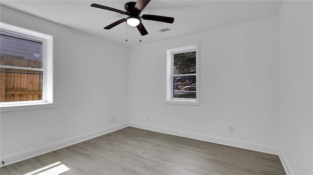 spare room with hardwood / wood-style flooring and ceiling fan