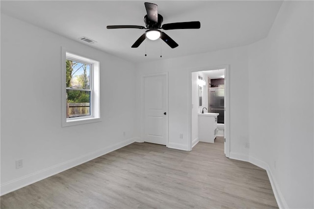 unfurnished bedroom featuring ensuite bath, ceiling fan, a closet, and light hardwood / wood-style floors