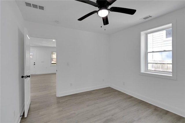 unfurnished room featuring ceiling fan, plenty of natural light, and light hardwood / wood-style flooring