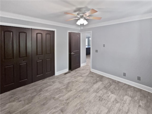 unfurnished bedroom with visible vents, ornamental molding, a closet, baseboards, and ceiling fan