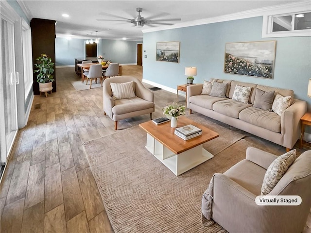 living room featuring light wood-type flooring, crown molding, and ceiling fan