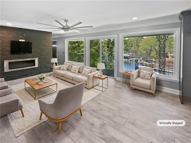 living room with recessed lighting, wood finished floors, baseboards, a fireplace, and ceiling fan