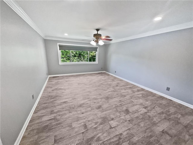 spare room featuring baseboards, a ceiling fan, and crown molding