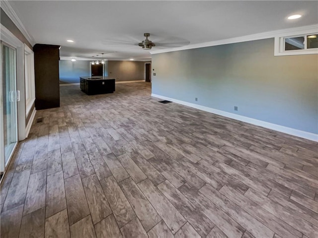 unfurnished living room with wood-type flooring, ornamental molding, and ceiling fan