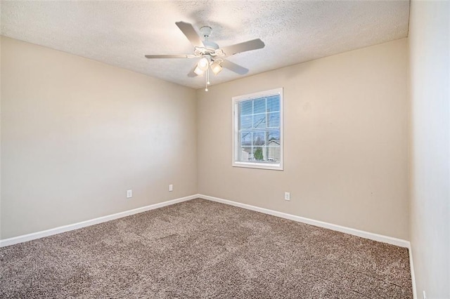 carpeted spare room featuring ceiling fan and a textured ceiling