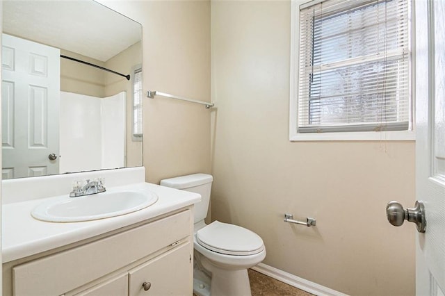 bathroom featuring walk in shower, vanity, and toilet