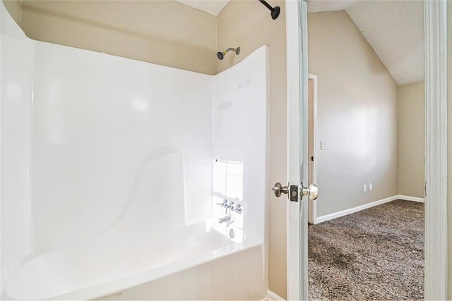 bathroom featuring vaulted ceiling and shower / bathing tub combination