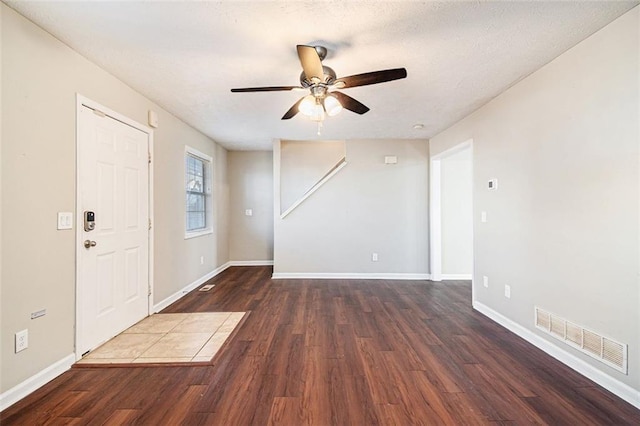 foyer entrance with dark hardwood / wood-style flooring and ceiling fan