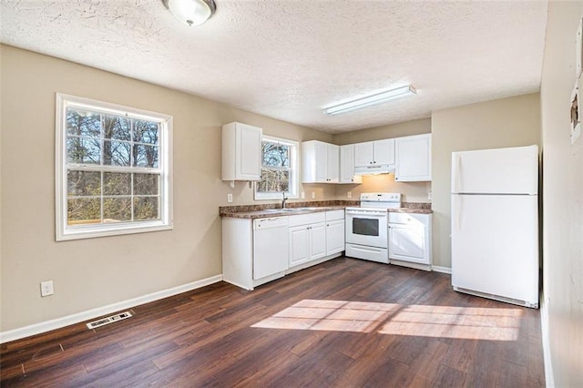 kitchen featuring white appliances, dark hardwood / wood-style flooring, and white cabinets