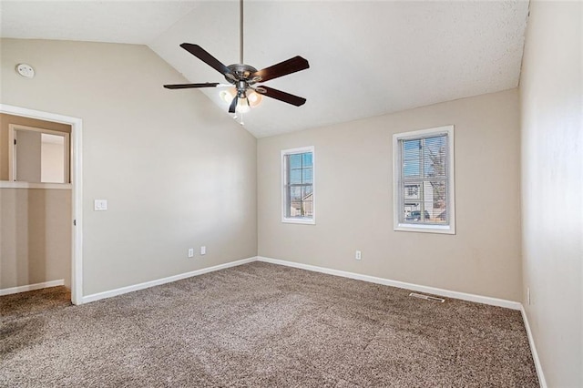 carpeted spare room with vaulted ceiling and ceiling fan