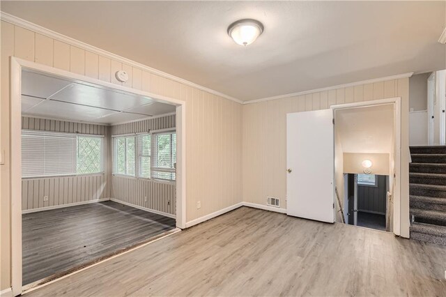 interior space featuring light hardwood / wood-style flooring and ornamental molding