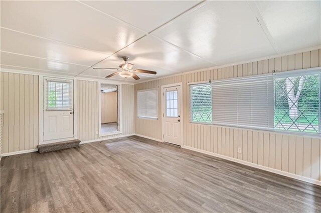 interior space with a healthy amount of sunlight, ceiling fan, and hardwood / wood-style floors