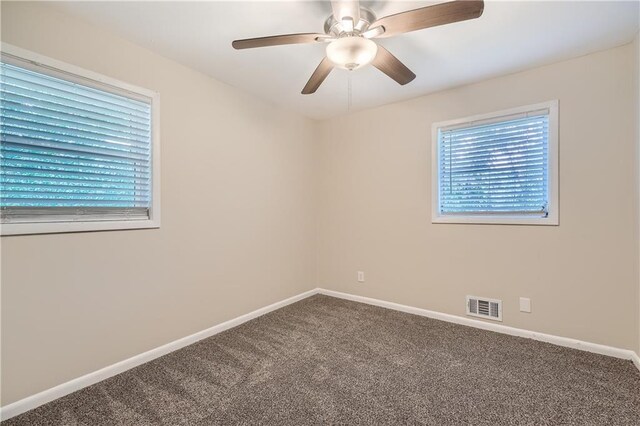 carpeted spare room with ceiling fan