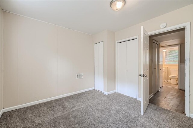 unfurnished bedroom featuring dark carpet