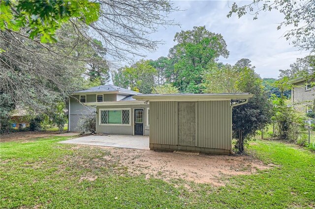 rear view of property with a lawn