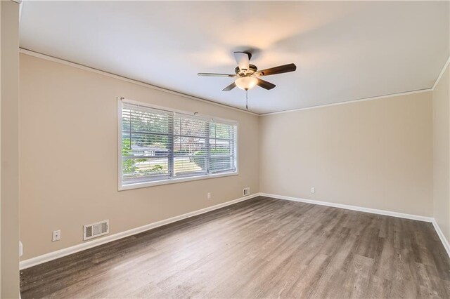 unfurnished room with ceiling fan, ornamental molding, and wood-type flooring