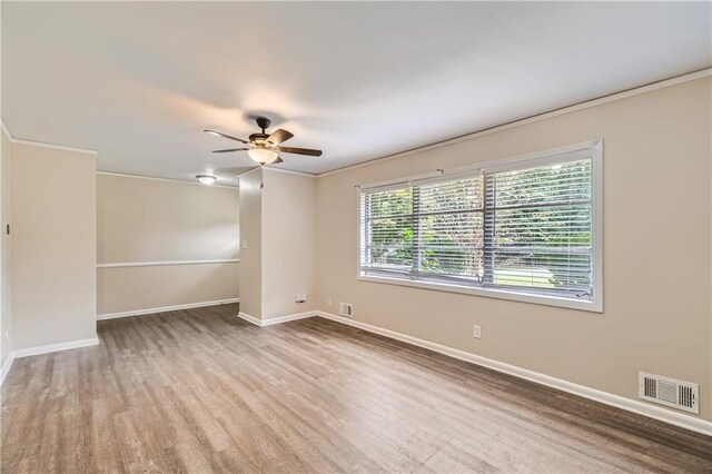 spare room featuring crown molding, ceiling fan, and hardwood / wood-style flooring