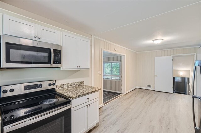 kitchen featuring appliances with stainless steel finishes, light hardwood / wood-style floors, white cabinetry, and light stone countertops