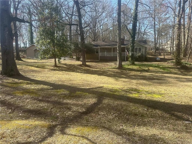 view of yard featuring covered porch